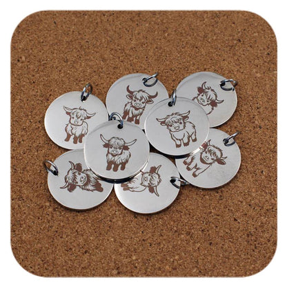 Silver pendants with different Highland Cows designs on cork background