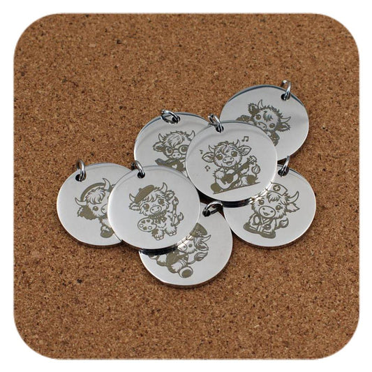 Silver pendants with different Scottish Highland Cow designs on cork background