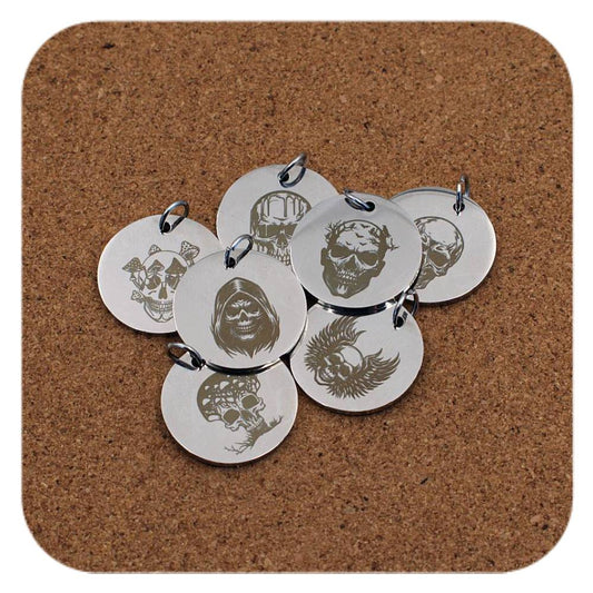 Silver pendants with different Skull Legends designs on cork background