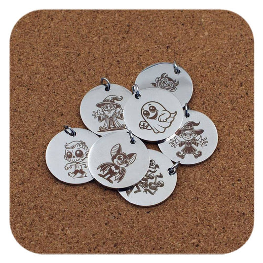 Silver pendants with different Halloween Magic designs on cork background