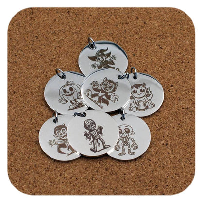 Silver pendants with different Spooky Halloween designs on cork background