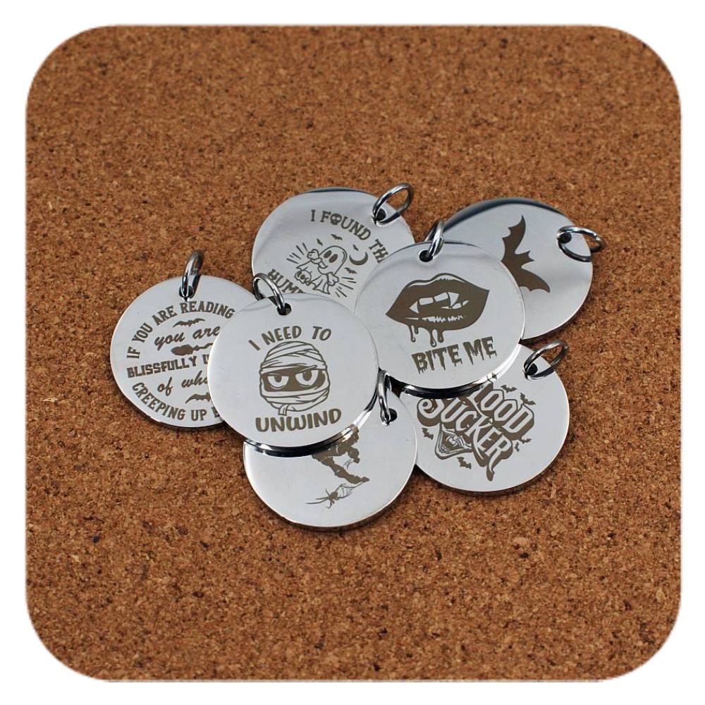 Silver pendants with different Halloween Vibes designs on cork background