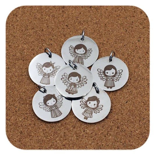 Silver pendants with different Festive Angel designs on cork background