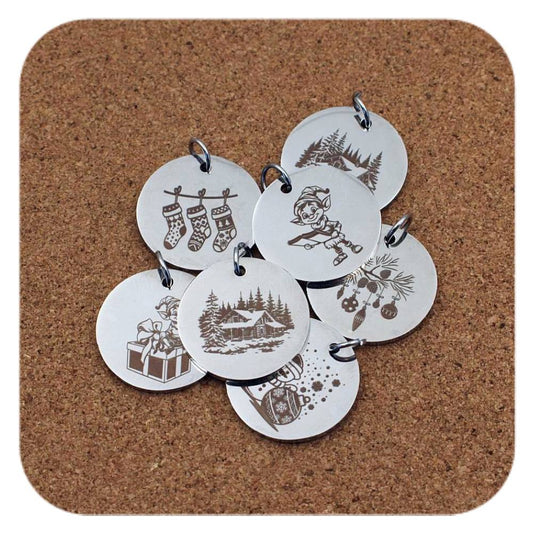 Silver pendants with different Christmas Yuletide designs on cork background
