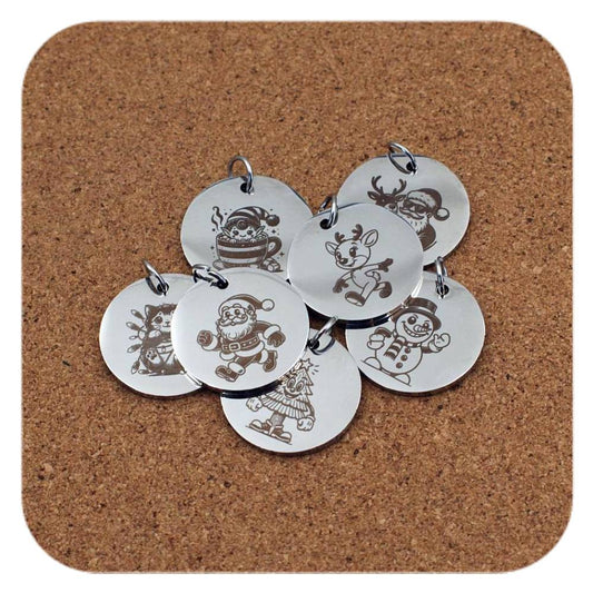 Silver pendants with different Christmas Spirit designs on cork background