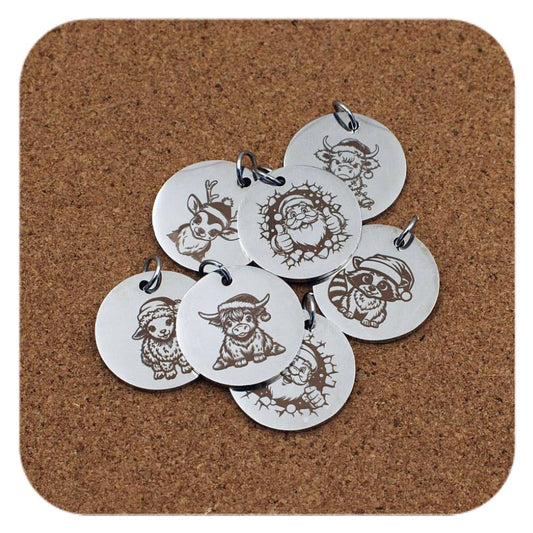 Silver pendants with different Christmas Magic designs on cork background