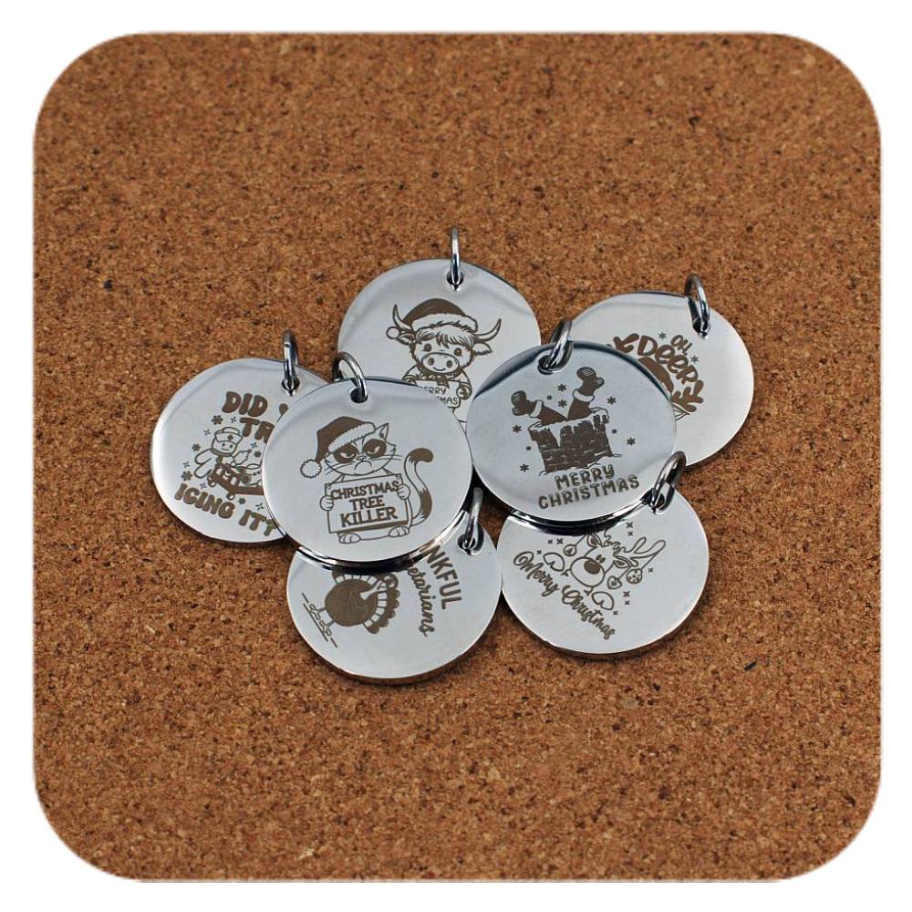 Silver pendants with different Christmas Fun designs on cork background