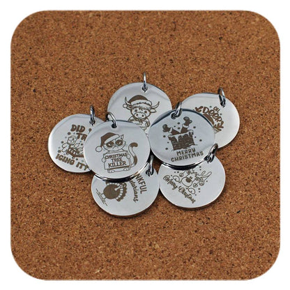 Silver pendants with different Christmas Fun designs on cork background