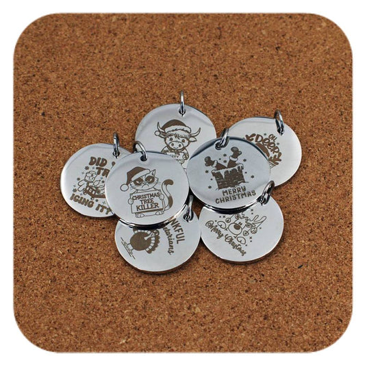 Silver pendants with different Christmas Fun designs on cork background