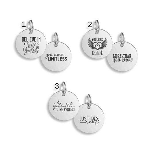 Silver pendants with different Positivity Quote designs on a white background