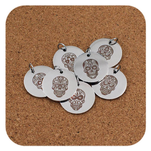 Silver pendants with different Sugar Skull designs on cork background