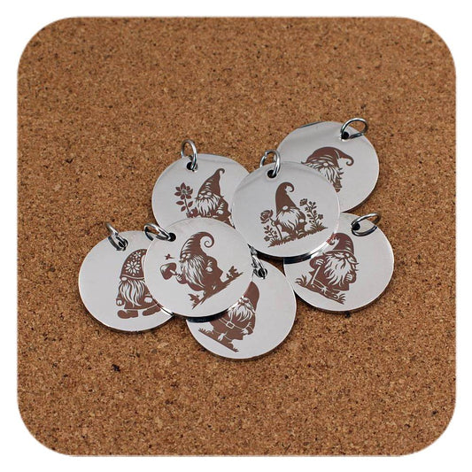 Silver pendants with different Garden Gnome designs on cork background