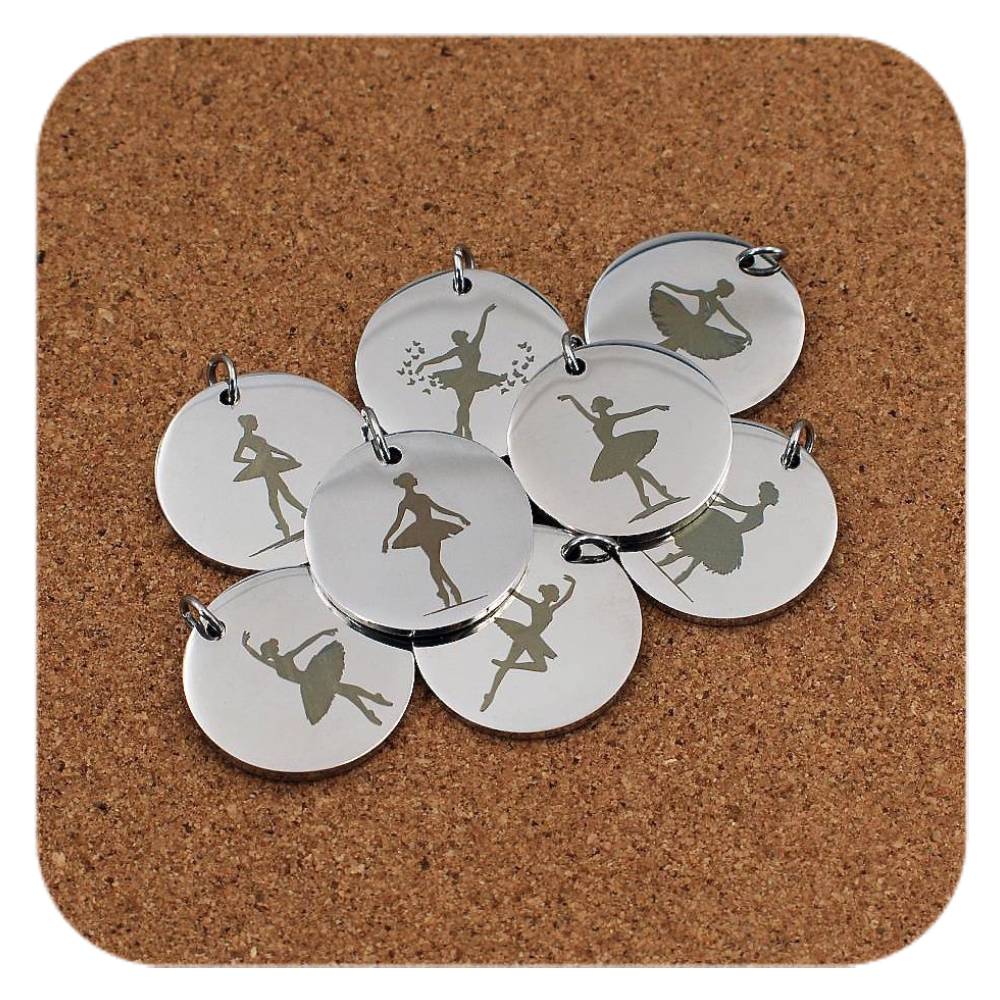 Silver pendants with different Ballerina designs on cork background
