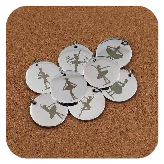 Silver pendants with different Ballerina designs on cork background