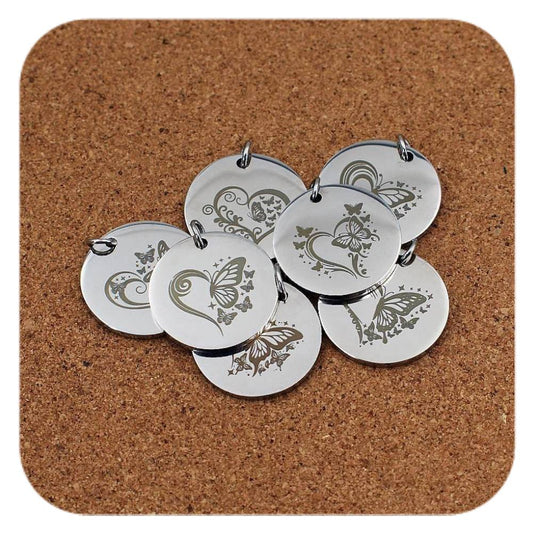 Silver pendants with different Hearts & Butterflies designs on cork background