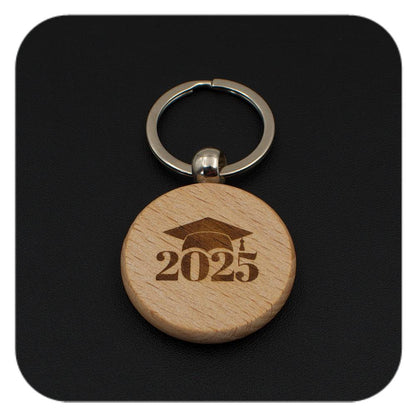 Wooden keyring with Graduation Cap 2025 design on black background