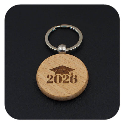 Wooden keyring with Graduation Cap 2026 design on black background