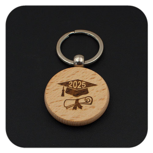 Wooden keyring with Graduation Cap Diploma 2025 design on black background