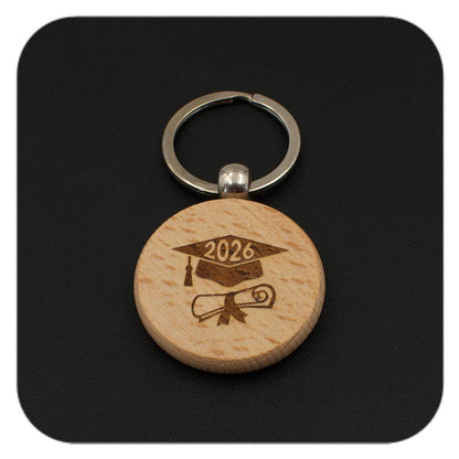 Wooden keyring with Graduation Cap Diploma 2026 design on black background