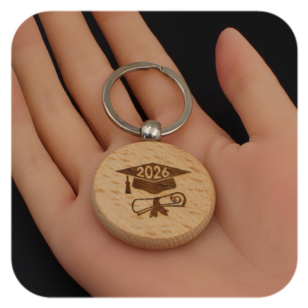 Wooden keyring with Graduation Cap Diploma 2026 design held in a hand