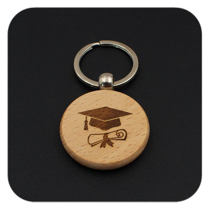 Wooden keyring with Graduation Cap Diploma design on black background