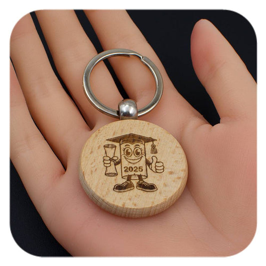 Wooden keyring with Novelty Graduation Diploma 2025 design held in a hand