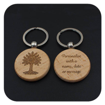 A keyring with Rowan Celtic Tree Zodiac design and another with sample wording on black background