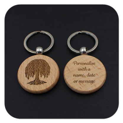 A keyring with Willow Celtic Tree Zodiac design and another with sample wording on black background