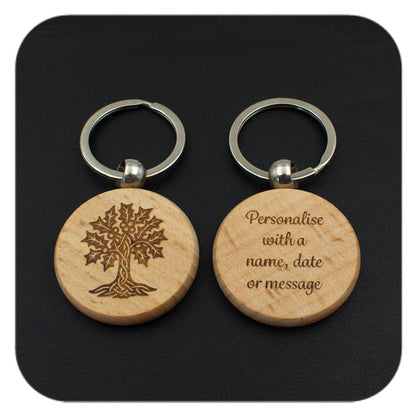 A keyring with Holly Celtic Tree Zodiac design and another with sample wording on black background